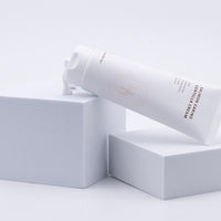 a tube of cream sitting on top of a white box