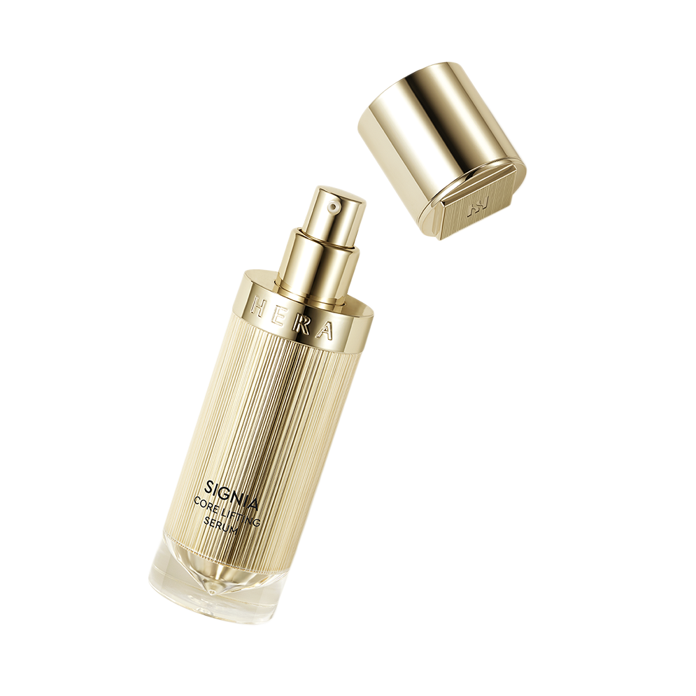 a bottle of perfume sitting next to a metal container