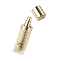 a bottle of perfume sitting next to a metal container