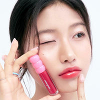 A 3g pot of Fruity Glass Gloss, radiating bright colors and a glossy texture for a lively, fruity makeup effect.