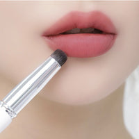 It features a slim, tapered brush head with soft, high-quality bristles that allow for detailed and accurate lip color application, including along the lip line.