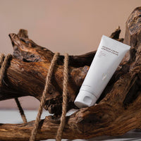 a tube of cream sitting on top of a piece of wood