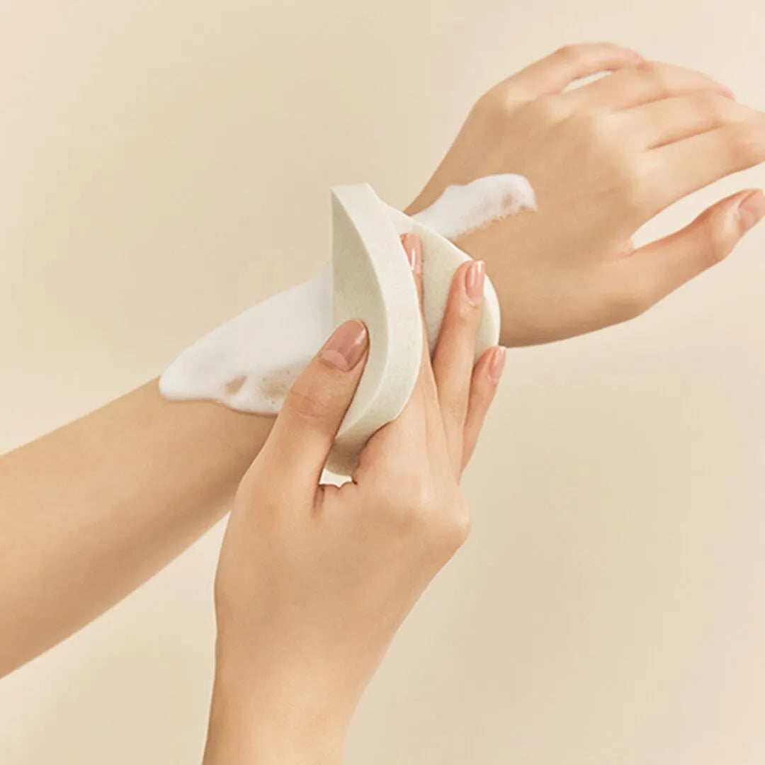 a woman's hands holding a white object in her left hand
